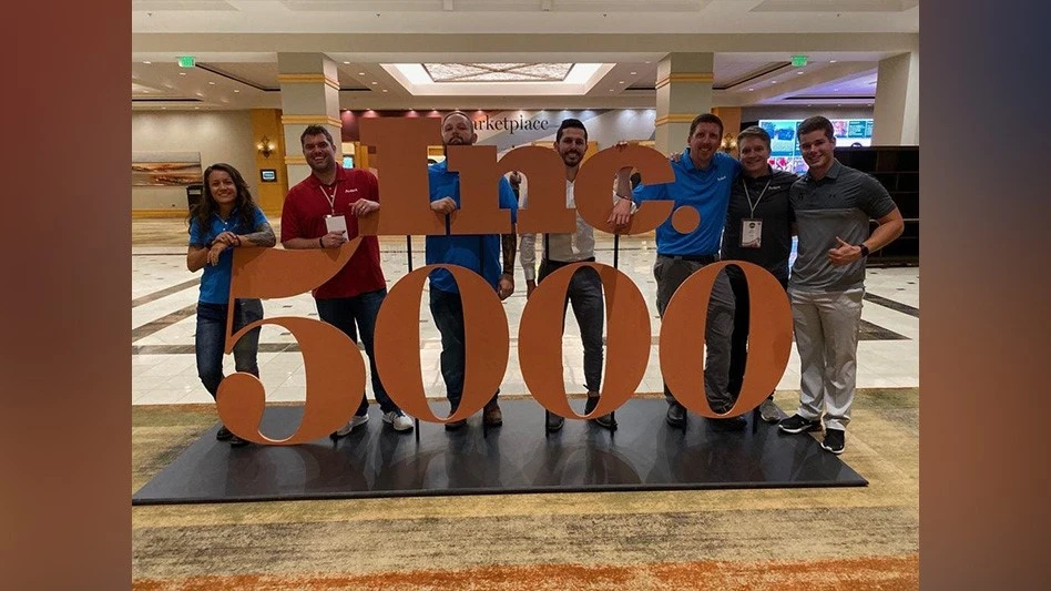Ardent employees pose in front of the Inc. 5000 statue