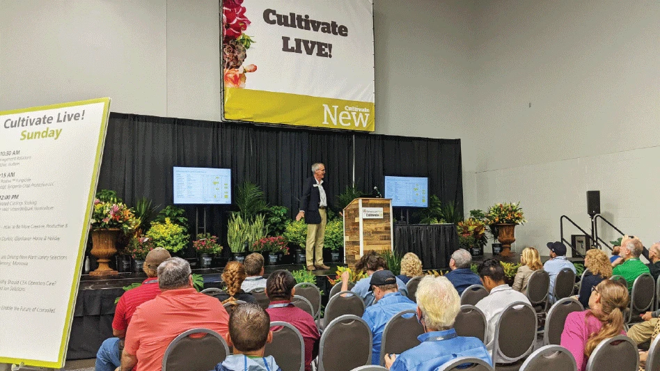 A group of people attend an education session at an industry tradeshow.
