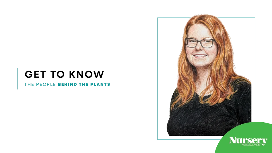 A woman with long red hair wearing a black shirt.