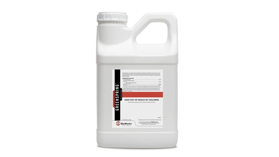 A white plastic jug with a white, red and black label reading GreenSpring.